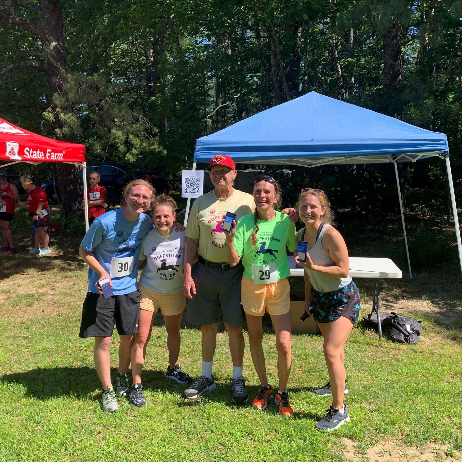 Family smiling for photo with race honoree